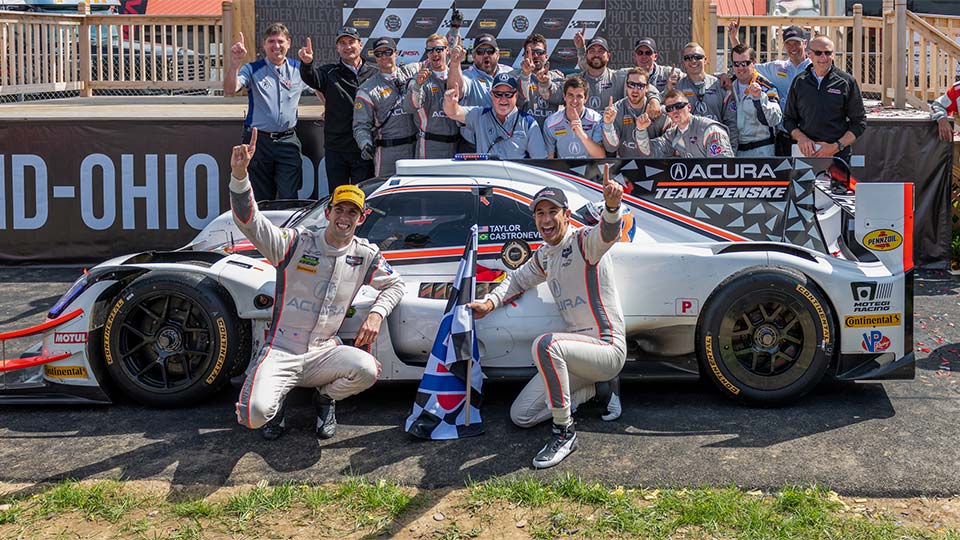Ricky Taylor and Helio Castronever pose in victory lane at the Mid-Ohio Sports Car Course